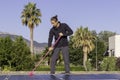 Side view of young man cleaning the solar panels of a solar power plant for renewable energy Royalty Free Stock Photo