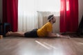 Young man doing the cobra pose in his living room Royalty Free Stock Photo