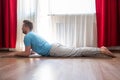 Young man doing the cobra pose in his living room Royalty Free Stock Photo