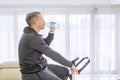 Side view of young man drinks water on a spin bike Royalty Free Stock Photo