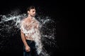 side view of young man with eyes closed swilled with water splash