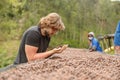 Man in glasses looking on coffee dried beans on hand at coffee farm Royalty Free Stock Photo