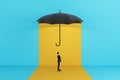 Side view of man standing under red umbrella on yellow background. Protection and insurance concept Royalty Free Stock Photo