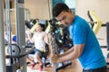 Young man exercising triceps pushdown during intense workout at the gym Royalty Free Stock Photo