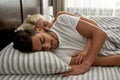 Side view of young multiethnic couple sleep on bed