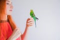 The beautiful woman admires her beautiful parrots Royalty Free Stock Photo