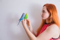 The beautiful woman admires her beautiful parrots Royalty Free Stock Photo