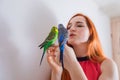 The beautiful woman admires her beautiful parrots Royalty Free Stock Photo