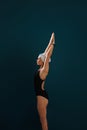 Side view of a young slim female swimmer preparing for competition Royalty Free Stock Photo