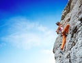 Young slim female rock climber climbing on the cliff Royalty Free Stock Photo