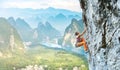 Young slim female rock climber climbing on the cliff Royalty Free Stock Photo