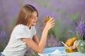 Smiling woman enjoying meal in lavender field. Royalty Free Stock Photo