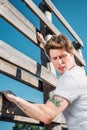 side view of young soldier climbing wooden barrier during obstacle run Royalty Free Stock Photo