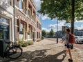 Side view of young tourist woman with a backpack discovering the Dutch city of