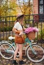 Young woman standing with bicycle in autumn park. Royalty Free Stock Photo