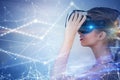 Young woman in vr glasses looks at graphs polygons