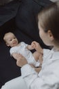 Side view of a young woman playing with her little baby in bed Royalty Free Stock Photo