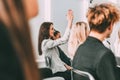 Young woman asks a question during a seminar Royalty Free Stock Photo