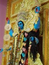 Side view of goddess Maa kali with a cut head on hand and garland with the head of asurs.