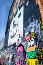 A side wall of building covered with graffiti art, London UK