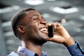 Side of young african american man talking on cellphone and laughing Royalty Free Stock Photo