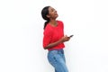 Side of young african american woman laughing with mobile phone against white background Royalty Free Stock Photo