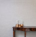 Sideboard in front of a grey wall with whiskey bottle