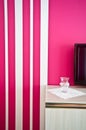 Sideboard with TV and red striped wall Royalty Free Stock Photo