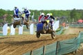 Sidecar motocross athletes overtaking in the air jump