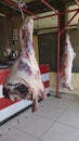 Sides of beef and lamb hanging in a BBQ restaurant