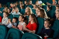 Sideview of laughing children in the cinema.