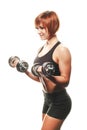 SIdeview of redhead female athlete with dumbbells