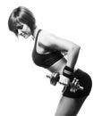 Sideview of redhead fit woman doing bent-over two-arm dumbbell t