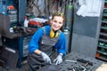 Sideview of worker woman marking piece of metal