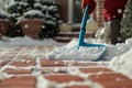 The sidewalk is being cleared of snow by a man after the storm Royalty Free Stock Photo