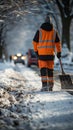 Sidewalk cleared by road worker in special attire, removing snow after snowstorm.