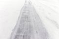 Sidewalk cleared of snow for safety during winter storm, covered