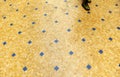 Sidewalk of a downtown street with grid mosaic pavement of small square marble pieces