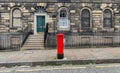 Sidewalk, facades and typical red british postbox