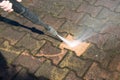 Sidewalk floor worker cleaning with high pressure water jet Royalty Free Stock Photo