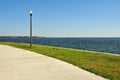 Sidewalk and lamppost near the water