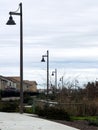 a sidewalk leading to an industrial looking area in a neighborhood