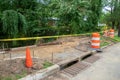 Sidewalk in the process of being replaced. Damaged concrete blocks have been removed and wooden boards placed to construct forms.