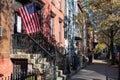 Sidewalk and Row of Colorful Old Homes in Greenpoint Brooklyn New York with an American Flag Royalty Free Stock Photo