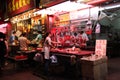 Sidewalk Vendors Selling Raw Meat and Cooked Food in Hong Kong Street Market