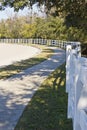 Sidewalk and white fence