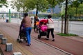 Sidewalk, women pushing baby carriages