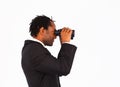 Sidewise closeup of businessman with binoculars