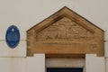 SIDMOUTH, DEVON, ENGLAND - APRIL 1ST 2021:The doorway arch of the original lifeboat station in Sidmouth stands next to a blue