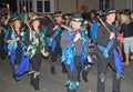 SIDMOUTH, DEVON, ENGLAND - AUGUST 10TH 2012: A group of Morris dancers dressed in decorated top hats and ragged blue waistcoats